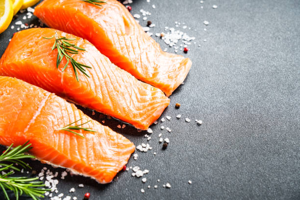 istock Salmon fillet, raw fresh fish with rosemary and spices. 1945534719