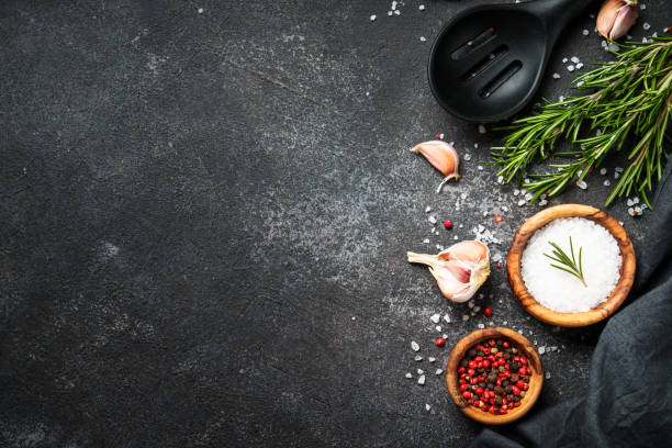 Spices and herbs at black top view. Food background. Spices and herbs at black top view with space for text. cooking with garlic stock pictures, royalty-free photos & images