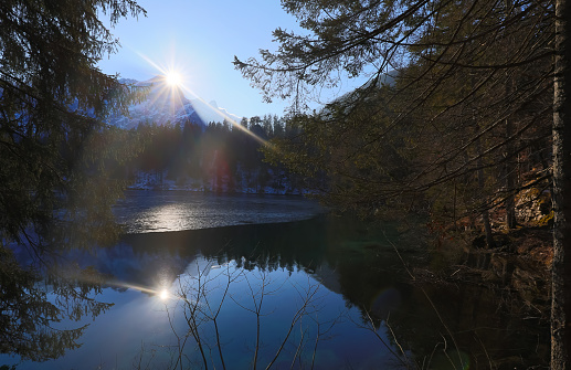 Jagged mountain peaks reflected in alpine lake