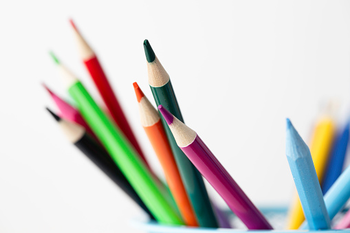 A collection of coloured pencils on white background.