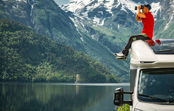 istock A Man Exploring Scenic Norwegian Landscape From His Camper Van Roof 1945566462