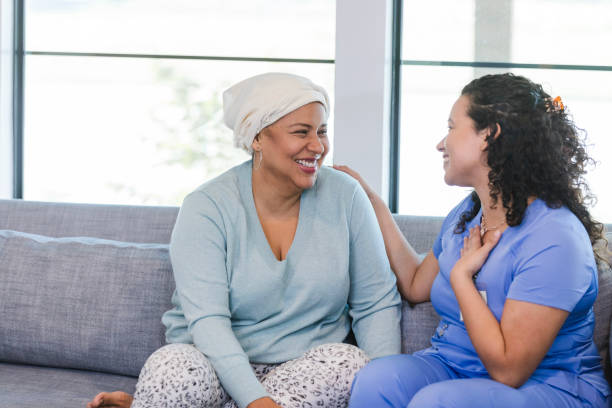 istock Visiting female nurse thanks female patient for compliment 1945606282