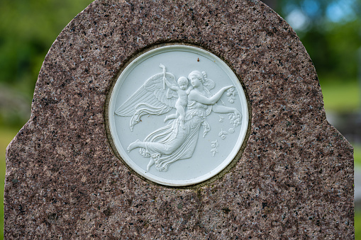 Farsund, Norway - July 02 2023: Porcelain mural on a grave stone.