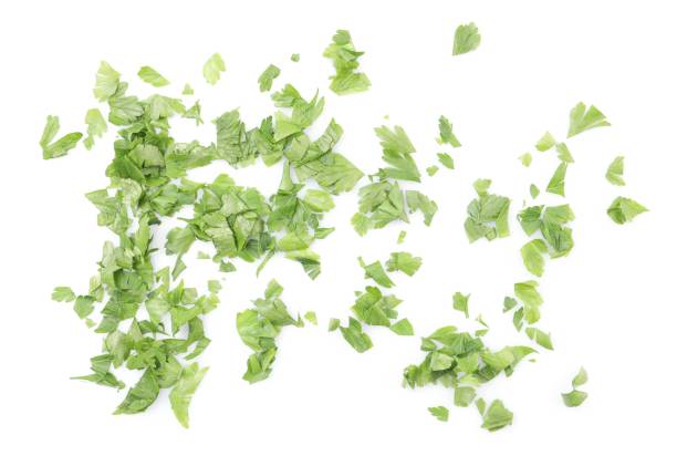 istock Chopped parsley leaves isolated on white, top view 1945672729