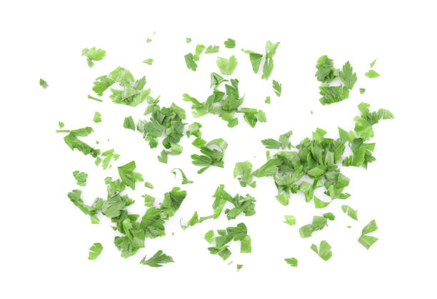 istock Chopped parsley leaves isolated on white, top view 1945673704