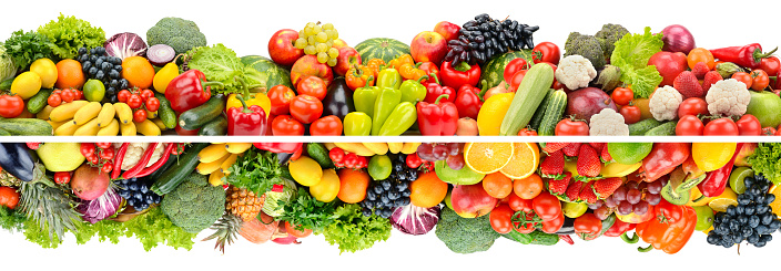 Wide composition of bright fruits, vegetables and berries isolated on white background.