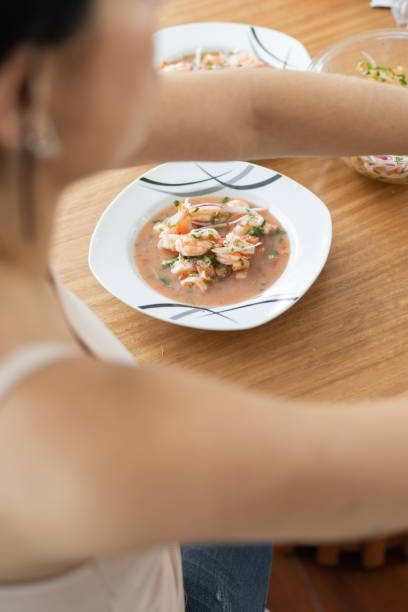 Gourmet raw seafood mexican salad with cucumbers and red hot sauce.