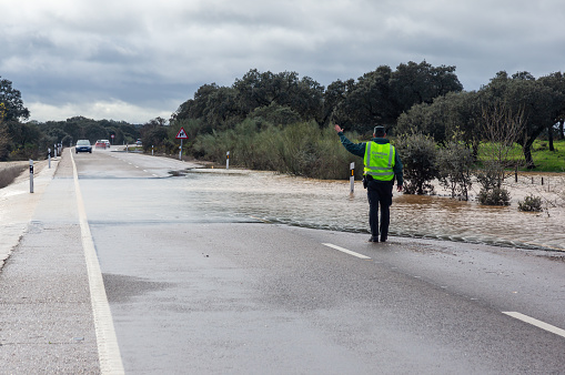 Badajoz, Spain. January 19, 2024. A Spanish Civil Guard officer directs traffic due to a water overflow and flooding caused by heavy rains.