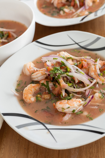 decoration of plate with shrimp ceviche, traditional food from Ecuador, studio photo as wallpaper, healthy food