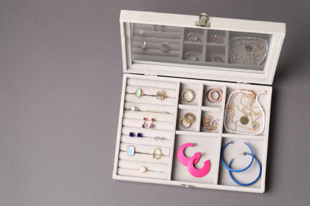 istock Jewelry box with many different accessories on gray background, top view. Space for text 1945705396