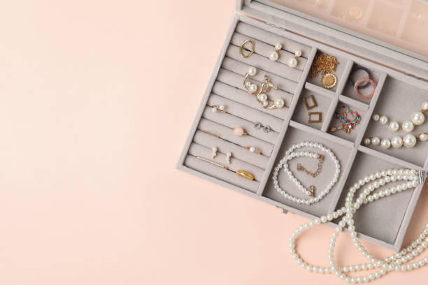 istock Jewelry box with many different accessories on beige background, top view. Space for text 1945705900