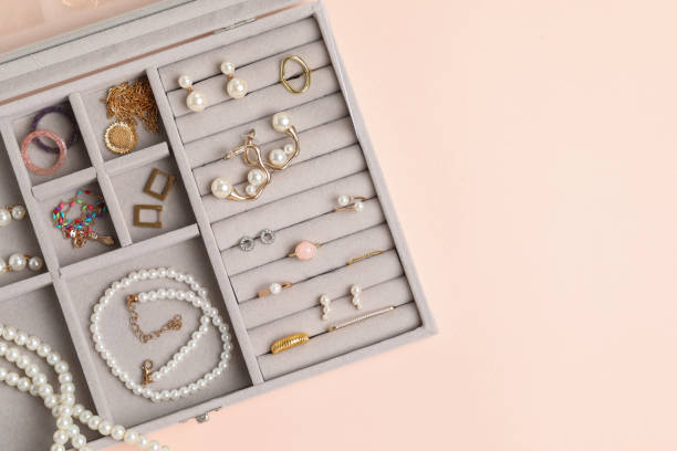 istock Jewelry box with many different accessories on beige background, top view. Space for text 1945705904