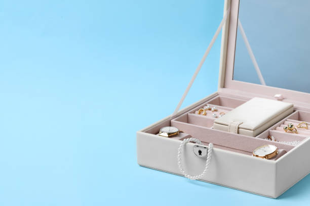 istock Jewelry box with many different accessories on light blue background, space for text 1945706979