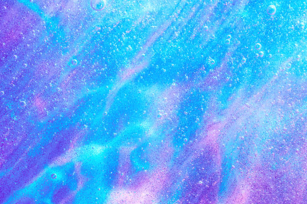 Beautiful neon purple, pink and blue transparent space alien glitter slime background texture. Sparkle cosmic, surreal abstract backdrop, ethereal, liquid art gel galaxy substance.