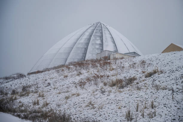 istock Winter Highway Snowing Landscape with Sand and Salt Storage Dome 1945737703
