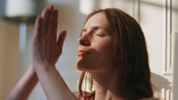 istock Peaceful girl practicing namaste position closeup. Serene model meditating home 1945772636