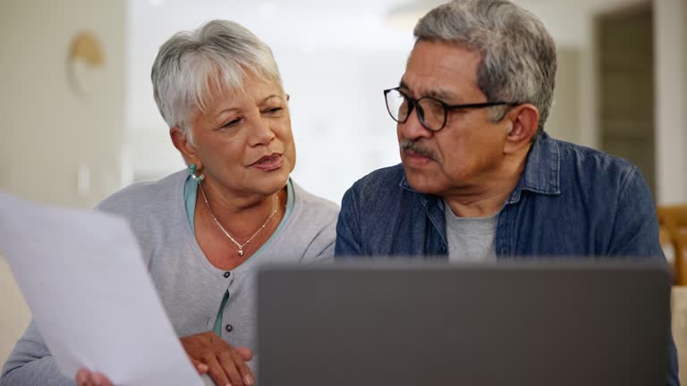 Old couple, laptop and paperwork, bills and taxes online with budget, life insurance and retirement fund. People at home with policy document, savings and asset management, finance and investment