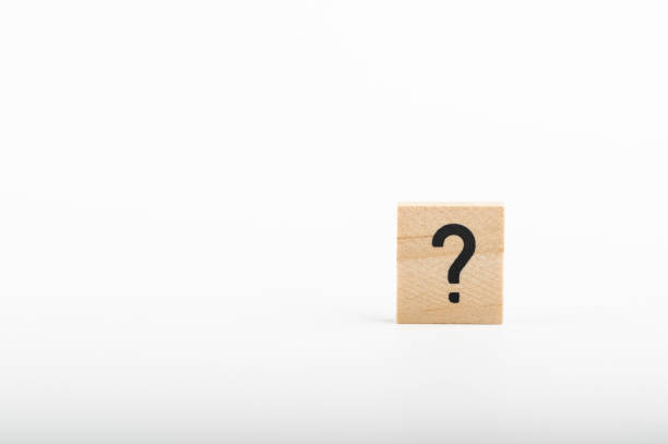 istock Wooden question mark tile on a white background 1945787859