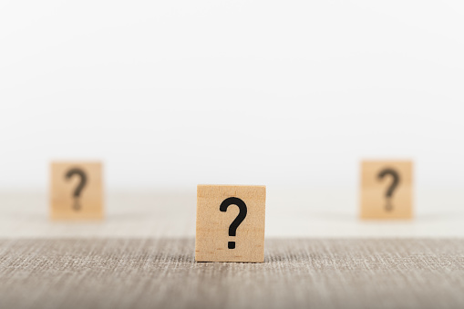 Wooden question mark tiles on a desk