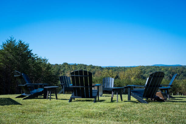 istock Black Adirondack Chairs on Green Grass Outdoors in the Mountains 1945792666