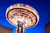 long exposure photograph of a chain carrousel at night