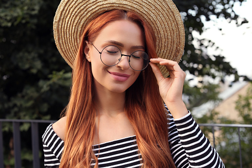 Portrait of beautiful woman in glasses outdoors