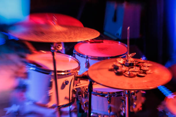 istock Drum Kit with Hi-Hat on Stage in Vibrant Red stage Light ready for live music performance 1945835256