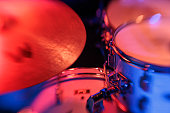 Close-Up of Drum Kit on Stage with Vibrant Red Lighting - Live Music Performance Equipment