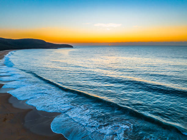 istock Pretty blue sunrise at the beach with calm seas 1945858663