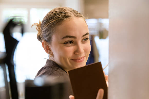 istock Teenage girl doing her makeup 1945876202