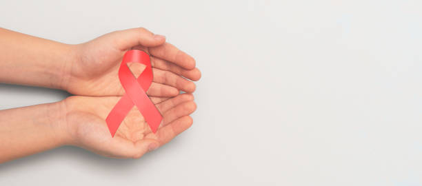 istock Man holding cancer awareness ribbon 1945880429