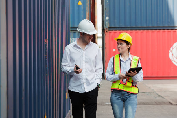 istock Businessman and woman taking together during check container terminal. 1945899735