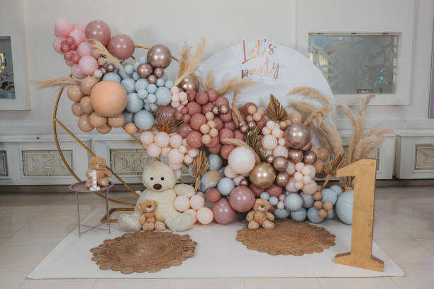 Photo-wall decoration with balloons, toll bear and number one.