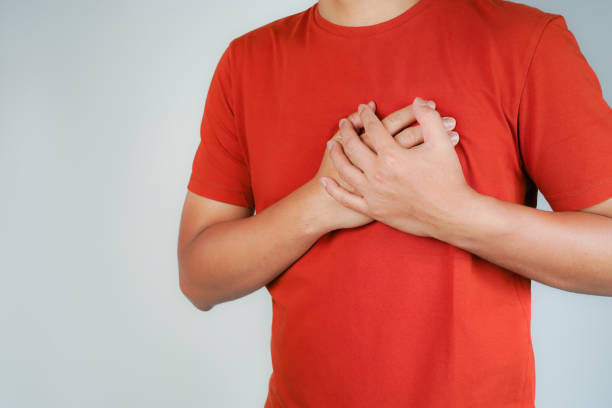 istock the man pressed his chest with a painful expression. Severe heartache, having a heart attack or painful cramps, heart disease 1945907292