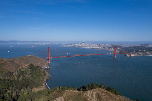 This photo captures the magnificent view of the Golden Gate Bridge from the top of a hill.