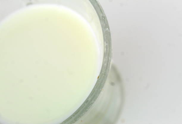 istock Glass of milk on a white table 1945912152