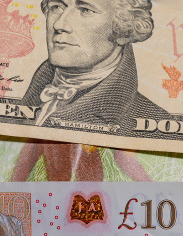 details of a genuine American banknote with a face value of 10, part of a ten-dollar bill of the United States of America close-up