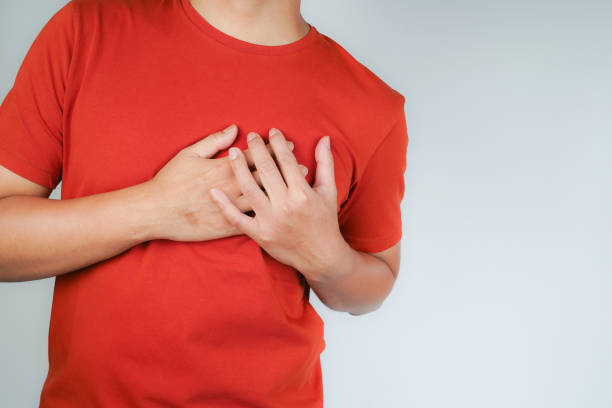 istock the man pressed his chest with a painful expression. Severe heartache, having a heart attack or painful cramps, heart disease 1945919678