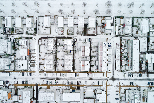 Residential neighborhood in the snow, top down view.