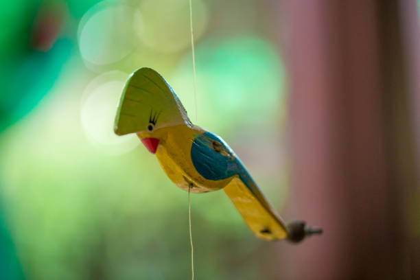 Wood crafted colorful parrot hanging stock photo
