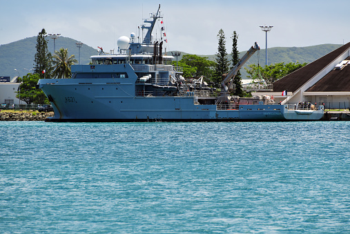 Nouméa, South Province, New Caledonia: French Navy oceanic patrol ship D'Entrecasteaux (A621), moored by the Maritime Museum - first vessel of its class (named after the French navigator Antoine Bruny d'Entrecasteaux), an overseas support and assistance vessel (BSAOM), aka multi-mission vessel (B2M), designed to perform sovereignty, law enforcement and logistics missions - developed and produced by Kership, built at the Piriou shipyard in Concarneau. The d'Entrecasteaux class vessels can be armed with two 12.7x99 mm (.50 cal.) machine guns.