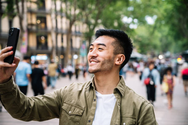 istock Happy Man Taking Selfie on City Street 1945974549
