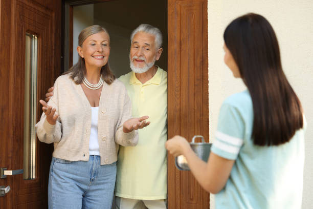 istock Friendly relationship with neighbours. Woman with saucepan visiting elderly couple 1945978742