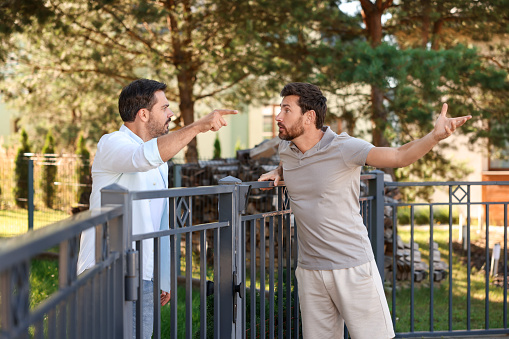 Soccer referee showing red card to soccer player.