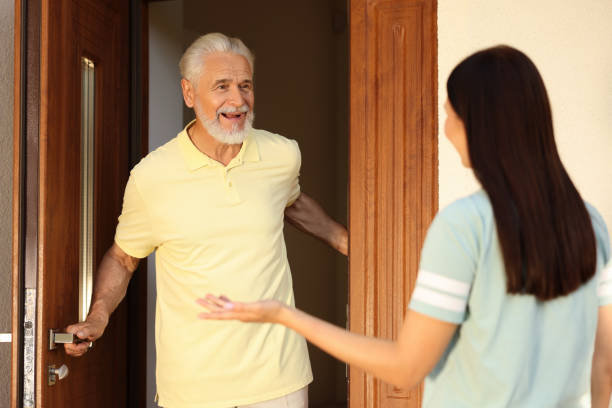 istock Friendly relationship with neighbours. Young woman visiting senior man 1945981351