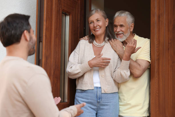 istock Friendly relationship with neighbours. Man visiting elderly couple 1945983470