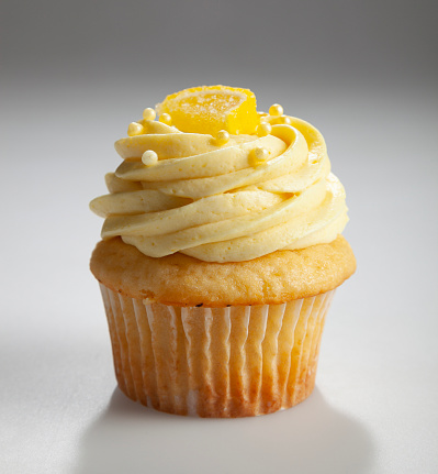 Gourmet lemon cupcake with lemon buttercream frosting and lemon candy on top