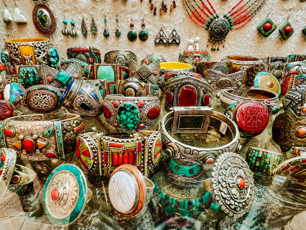 a selection of traditional jewelry and ceramics displayed at a souk vendor in tangier, morocco - craft market morocco shoe 뉴스 사진 이미지