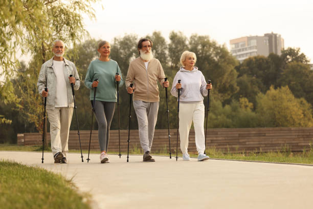istock Group of senior people performing Nordic walking outdoors, space for text. Low angle view 1946086893