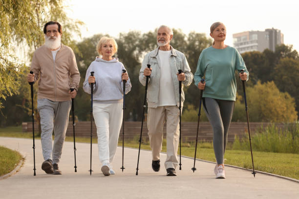 istock Group of senior people performing Nordic walking outdoors. Low angle view 1946086897